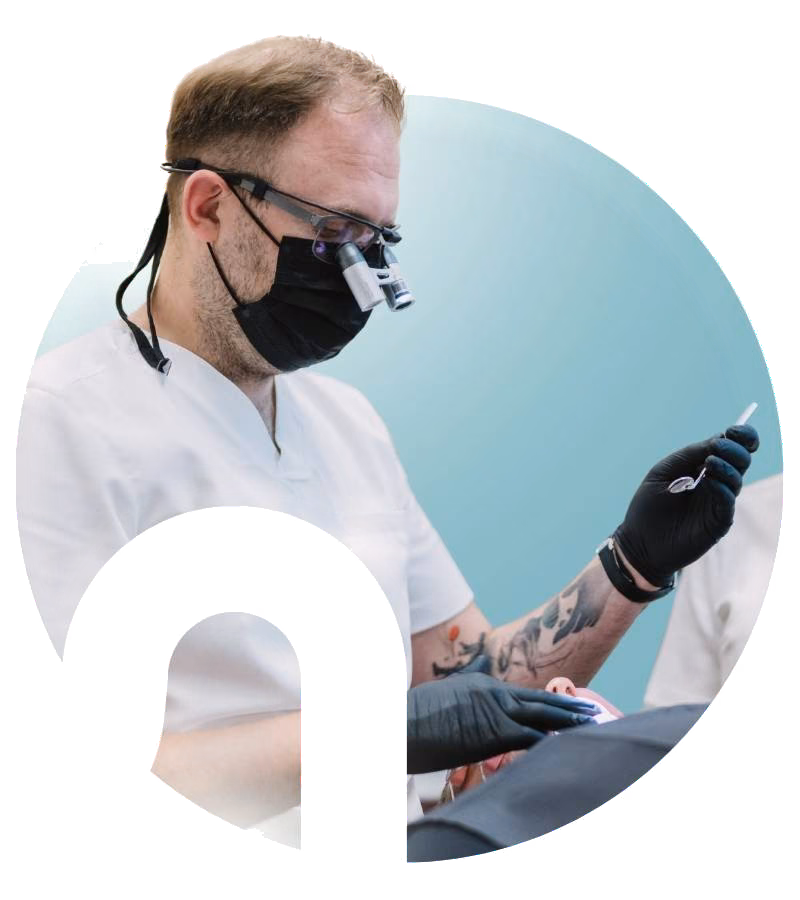 A dentist wearing surgical loupes at Flow Dental Studio