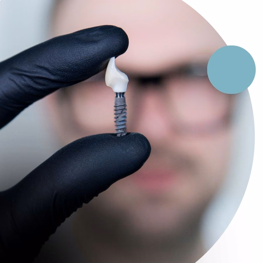 A single-tooth implant in a dentist's hand